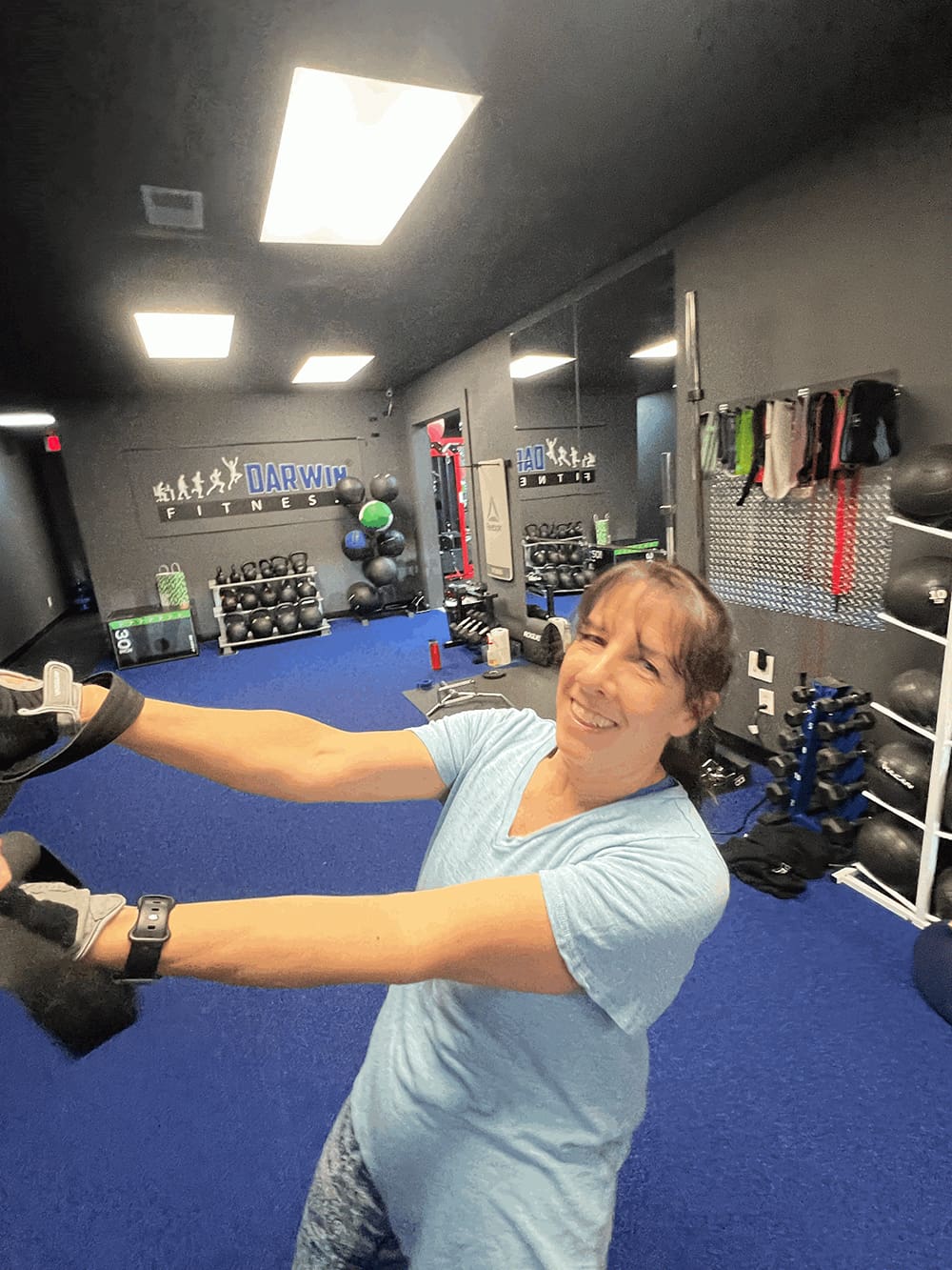 orwin-manor-personal-trainer-2 a smiling orwin manor area resident in mid-workout at darwin fitness private studio on lee road, demonstrating sustainable weight loss results achieved while balancing a professional career and social life along the mills 50