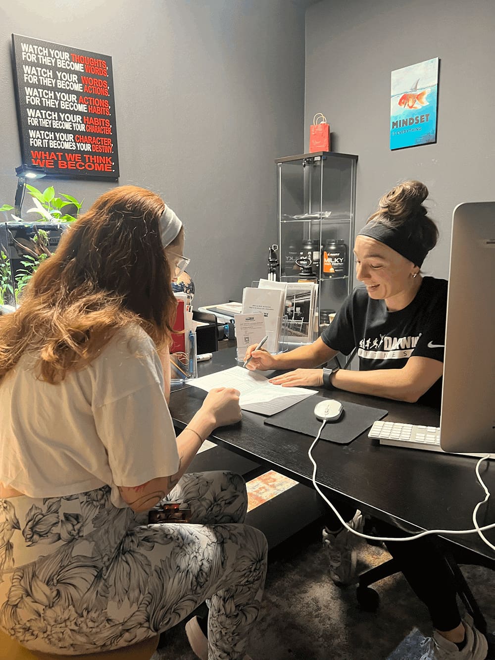 orwin-manor-personal-trainer-3 a certified personal trainer and nutrition coach at darwin fitness reviewing scientific inbody body composition scan data with a client, discussing fat loss progress and metabolic health metrics in a private consultation setting